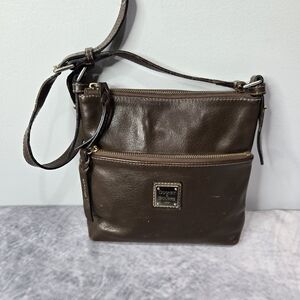 Dooney & Bourke Pebble Leather Letter Carrier crossbody bag. It is a vintage-sty